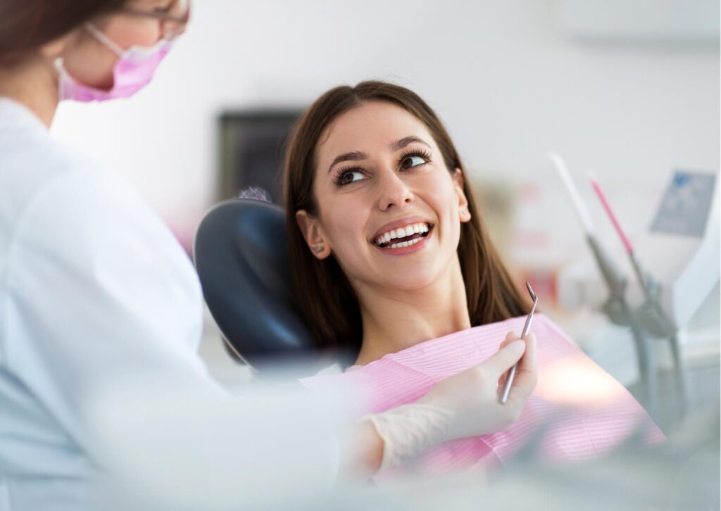 Patient discussing smile goals with a dentist while comparing teeth whitening strip effectiveness with professional whitening options.