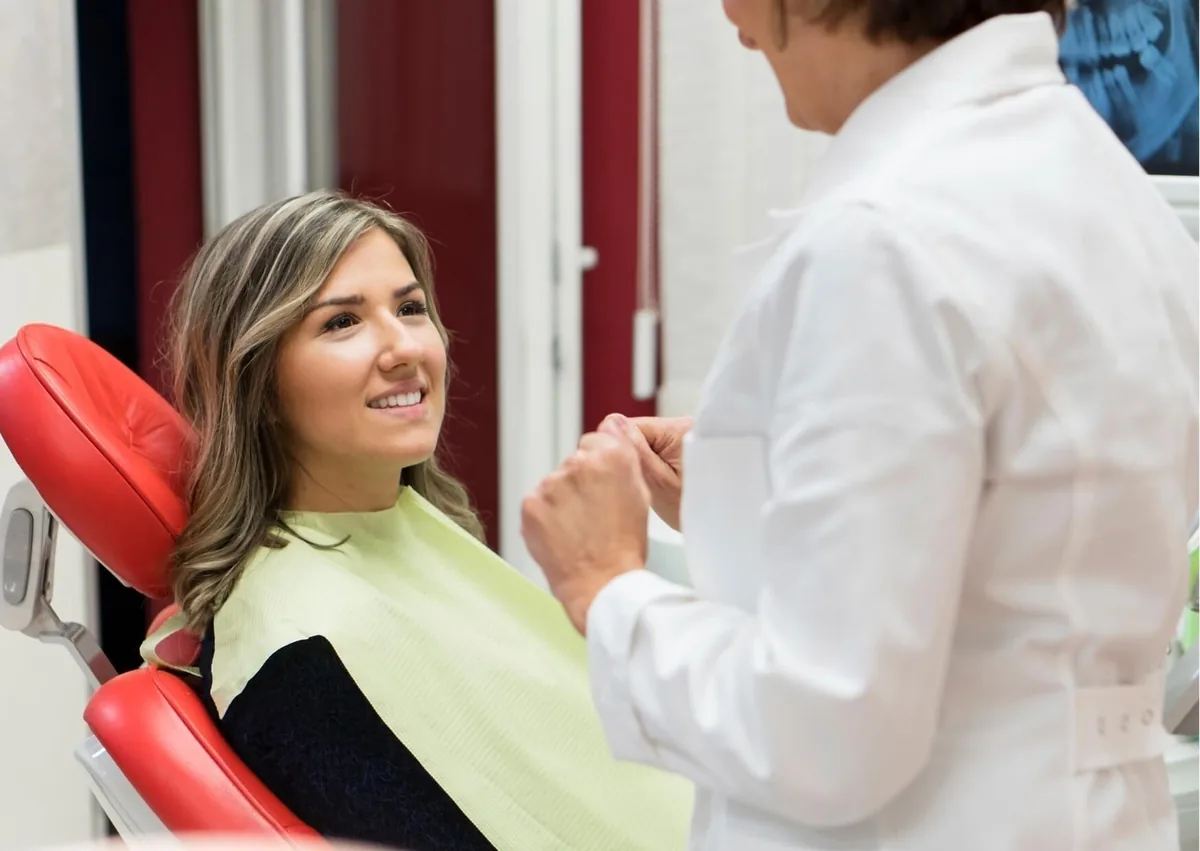 Patient discussing dental bonding options with a dentist to improve the appearance of her smile.