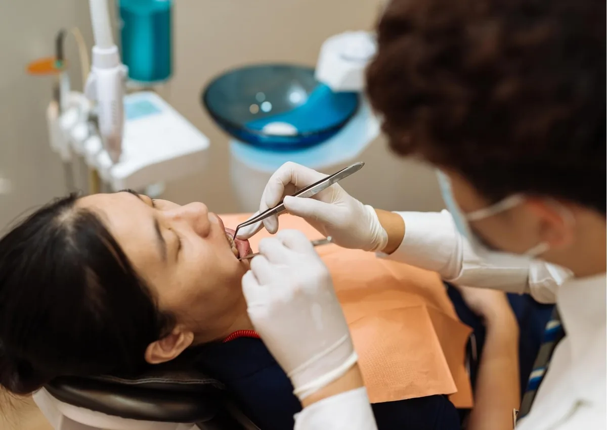 Dentist examining a patient’s teeth during a preventive dental visit to help prevent cavities.