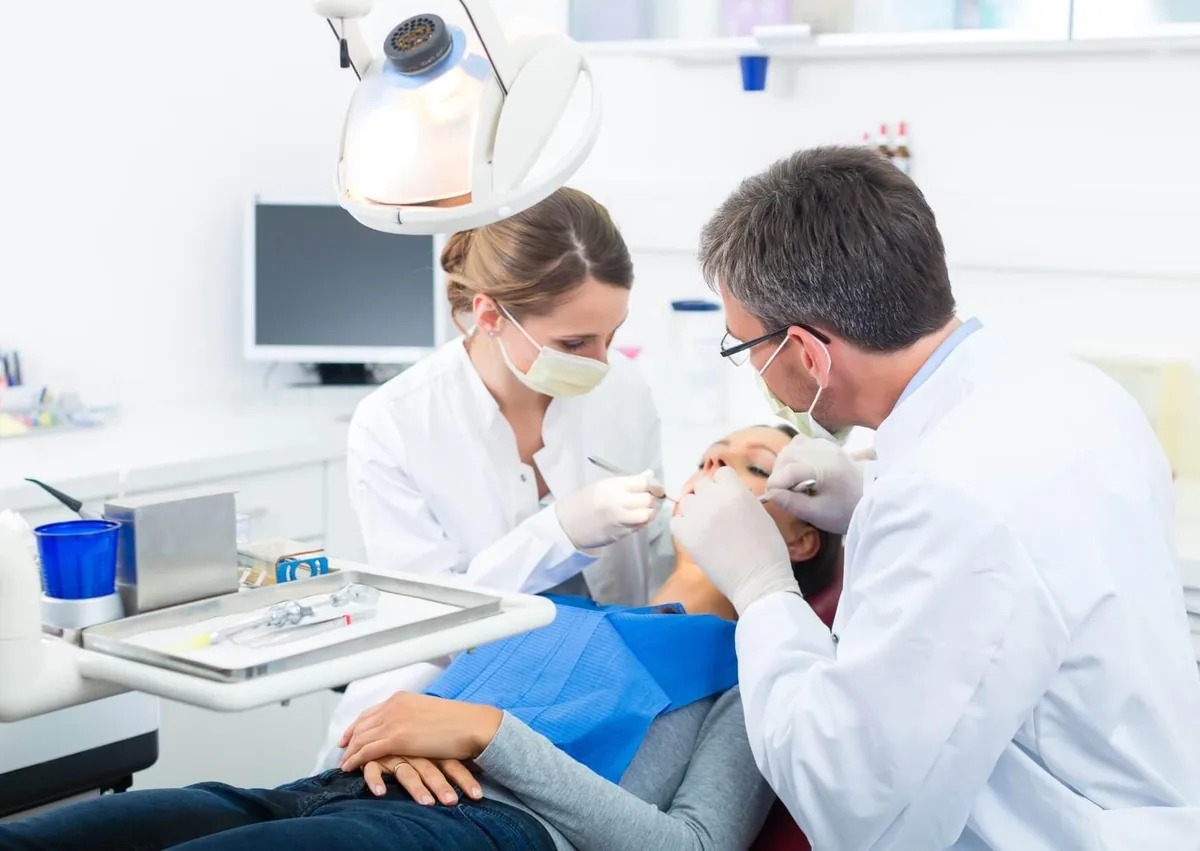Dental team treating a patient as part of an affordable dental implant procedure.